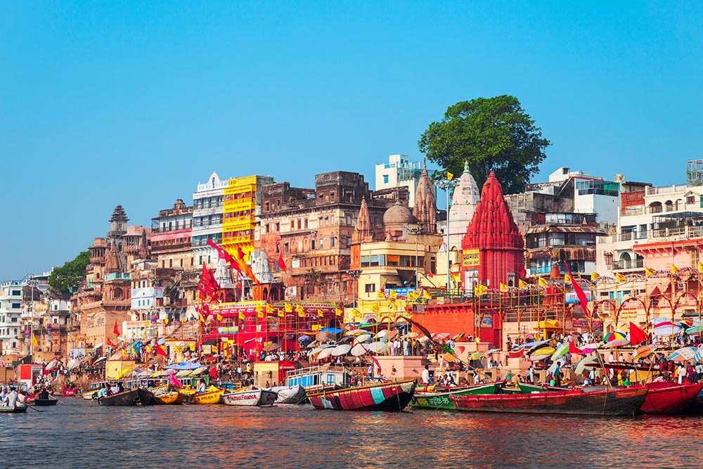 VARANASI, INDIA - APRIL 12, 2012: Colorful boats and Ganges river bank in Varanasi city in India
