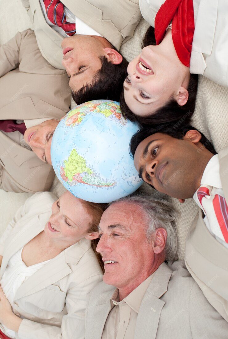 multi-ethnic-business-team-lying-floor-around-terrestrial-globe_13339-27290
